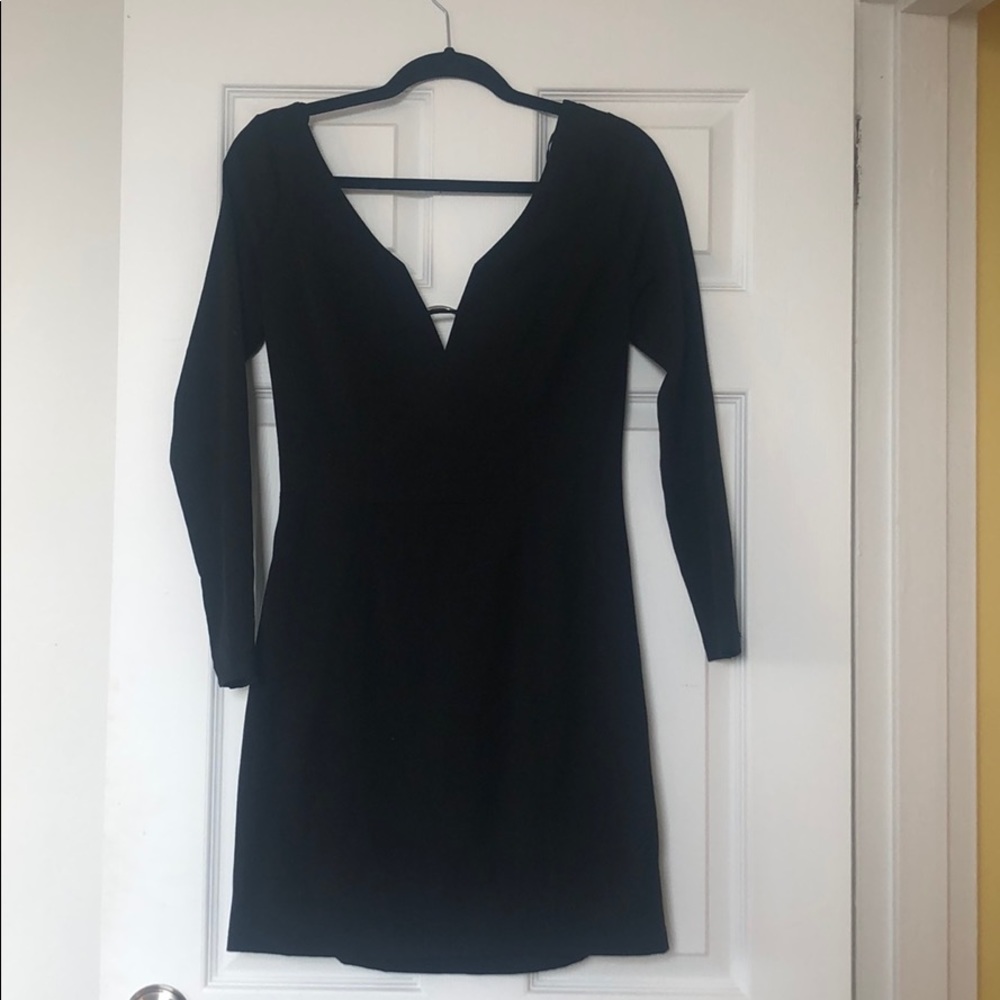 Mini black form fitting mini dress w long sleeves.